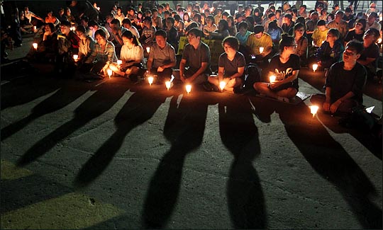 세월호 참사 100일을 2시간여 앞둔 23일 저녁 전남 진도군 팽목항에서 열린 '100일의 기다림'에서 참석자들이 실종자들의 귀환과 희생자들을 기리는 촛불을 들고 있다. ⓒ데일리안 박항구 기자 