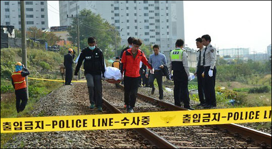 경찰의 날인 21일 선로에 누워있던 장애인을 구하려던 경찰관이 열차에 치여 사망하는 사고가 발생했다. 사진은 경찰관들이 시신을 수습하는 모습. ⓒ연합뉴스