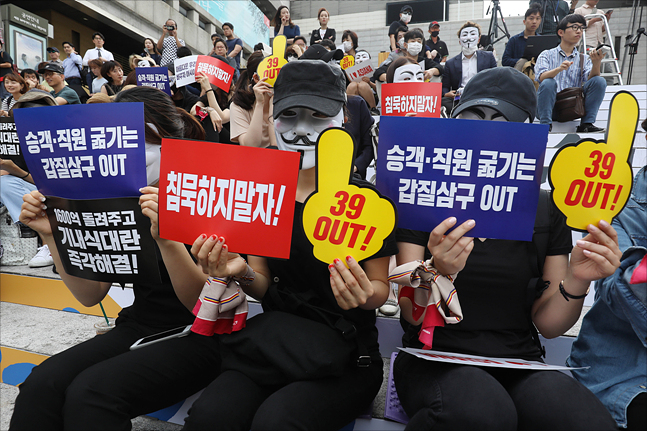 아시아나항공 직원들이 6일 오후 6시 서울 종로구 세종문화회관 앞 계단에서 ‘아시아나항공 노밀(No Meal) 사태 책임 경영진 규탄 문화제’에서 피켓을 들고 구호를 외치고 있다.ⓒ데일리안 홍금표 기자