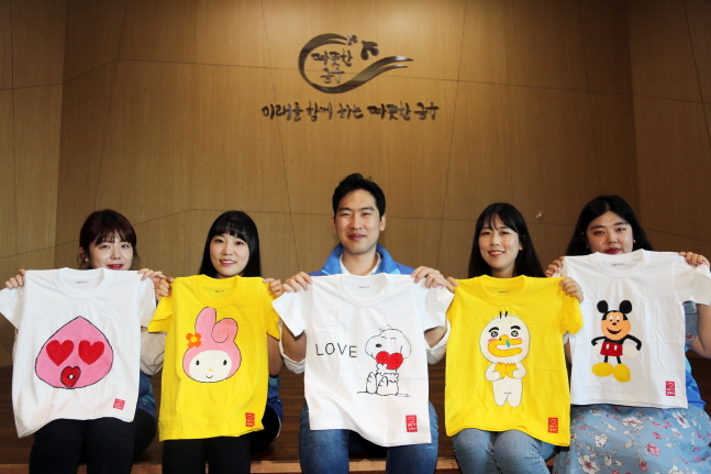 신한생명 '희망T 캠페인'에 참여한 직원들이 제작한 티셔츠를 들고 기념촬영을 하고 있다.ⓒ신한생명