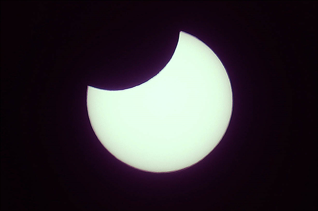 6일 오전 서울 성북구에서 바라본 하늘에 태양이 달에 가려지는 부분일식 현상이 관측되고 있다. ⓒ데일리안 홍금표 기자