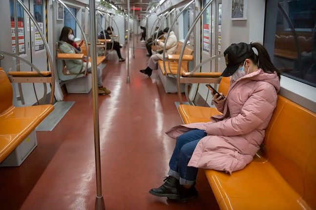 3일(현지시간) 중국 베이징에서 마스크를 쓴 시민들이 출근 시간대 거의 텅 빈 상태로 운행되는 지하철을 이용하고 있다. ⓒ뉴시스