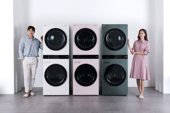 LG전자 모델들이 원바디 세탁건조기 ‘트롬 워시타워’ 새로운 색상의 3종 신제품을 소개하고 있다. 왼쪽부터 샌드 베이지, 코랄 핑크, 포레스트 그린.ⓒLG전자