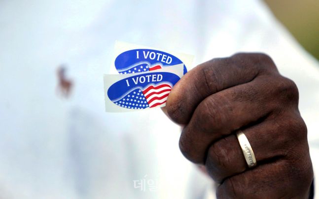 미국의 한 유권자가 사전투표를 마치고 '나는 투표했다'는 스티커를 쥐어든 모습(자료사진). ⓒAP/뉴시스