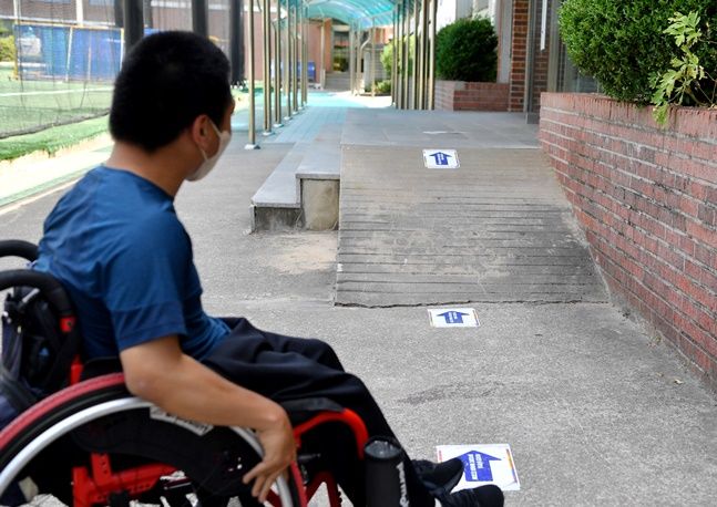 경사로를 바라보고 있는 휠체어 탄 장애인. 기사 내용과는 무관.ⓒ뉴시스