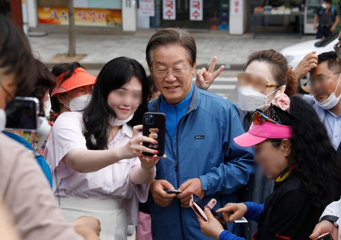 이재명 더불어민주당 대표가 지난해 6월 인천 계양산 야외공연장에서 열린 '이재명과 위로걸음, 같이 걸을까' 만남에서 여성 지지자들과 인사를 나누고 있다. ⓒ뉴시스
